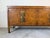 A striking vintage credenza in the style of William Doezema for Mastercraft, featuring richly figured burl wood veneer...