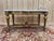 A louis xvi style coffee table in carved wood, regilded with gold paint, with a white carrara marble top veined with gray...