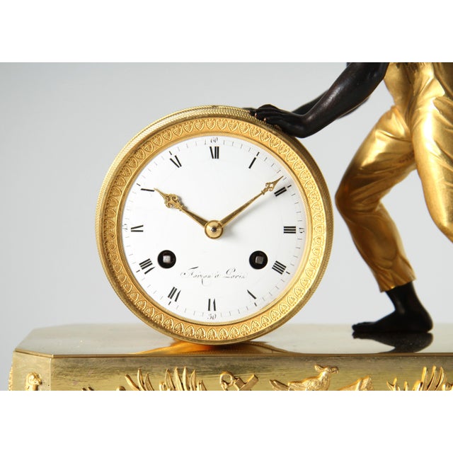 The barrel roller - so-called "pendule au noir" paris fire-gilt bronze early 19th century dimensions: h x w x d: 34 x 27 x...