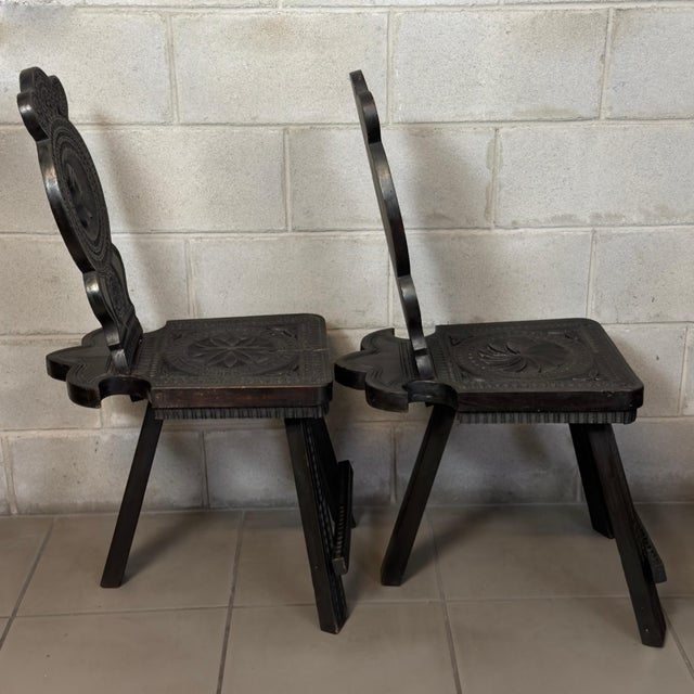An elegant pair of three-legged stool-style chairs attributable to 19th-century Italian craftsmanship, in the Neo-...