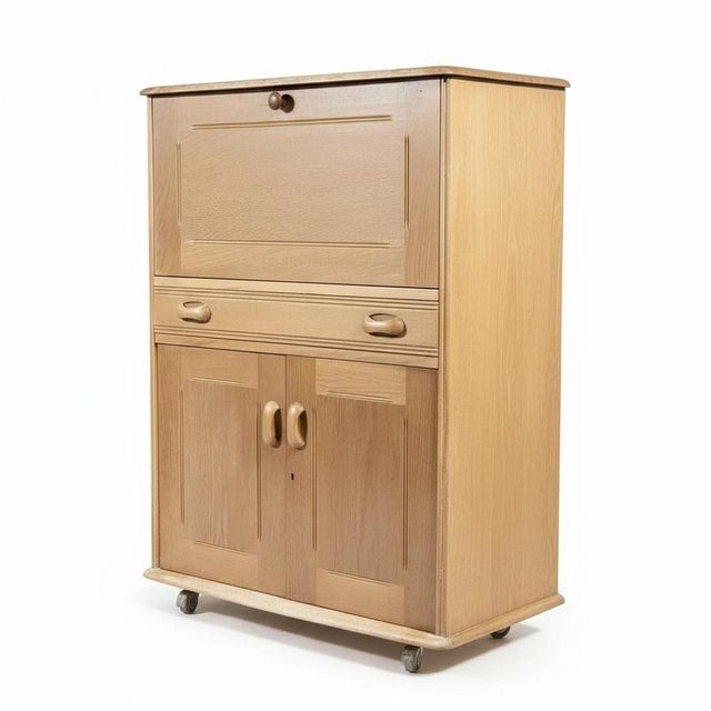 This vintage oak bureau is a classic British craftsmanship piece that serves as a versatile and compact writing desk ideal...