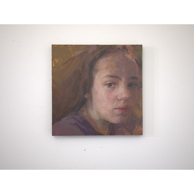 This oil painting presents a tender portrait of a young girl, capturing her introspective gaze and subtle expressions. The...