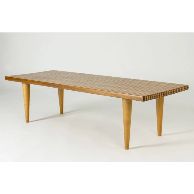 Amazing coffee table by Yngvar Sandström, in a striped pattern created by alternating teak and birch in the solid wood...