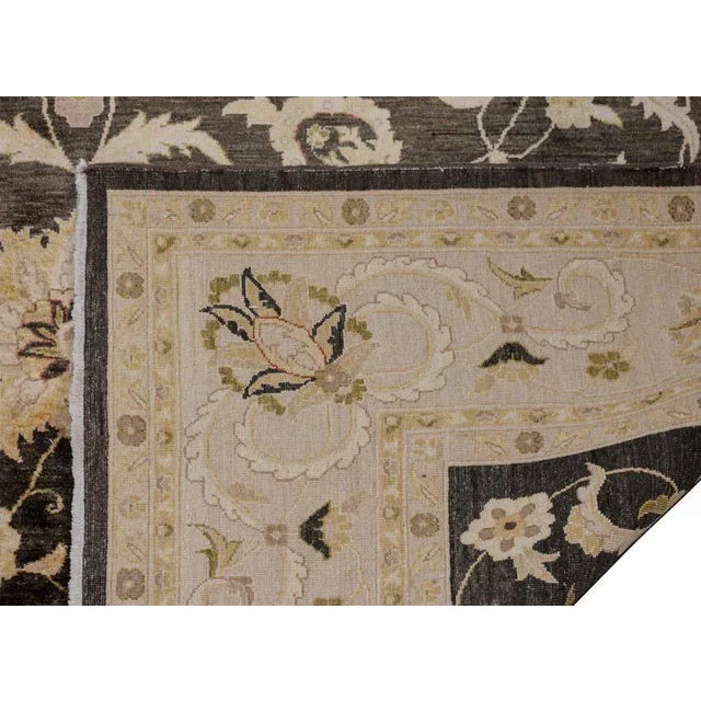 A wonderful vintage Pakistani rug with an all-over field of large flowers and scrolling vines woven in muted greens and...