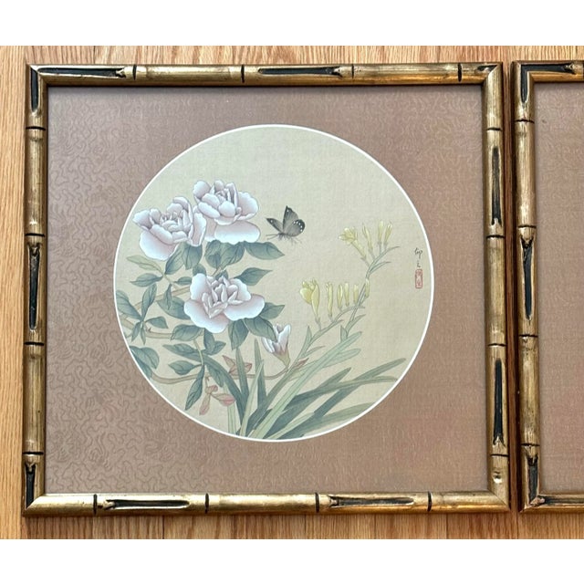 Beautiful Asian pair of botanical and butterfly paintings in vivid gouache watercolor on fabric. Framed with the gilt gold...