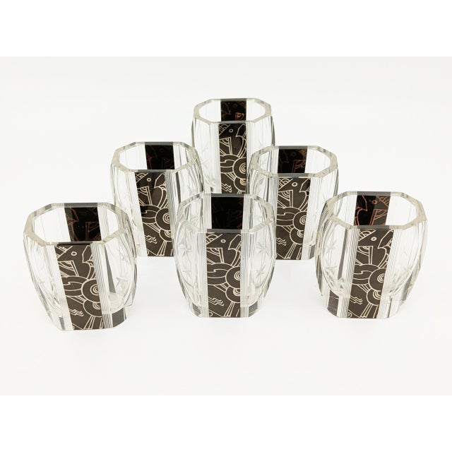 Splendid and rare decanter set in cut glass with black Art Deco decorations on a mirrored background. This set, of high...