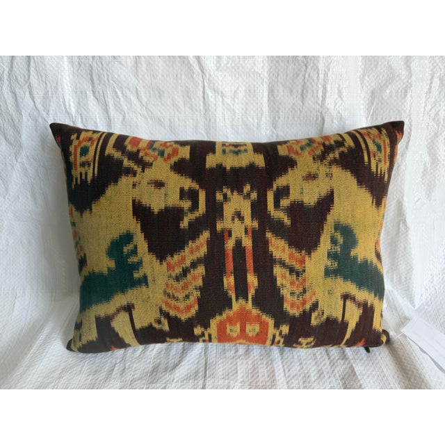 This beautiful decorative pillow showcases an authentic 19th century ikat fragment transformed into an elegant furnishing...