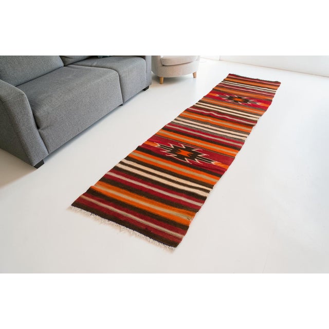 This is a vintage Turkish Oushak rug from the Mid 20th Century. The piece was hand-knotted.