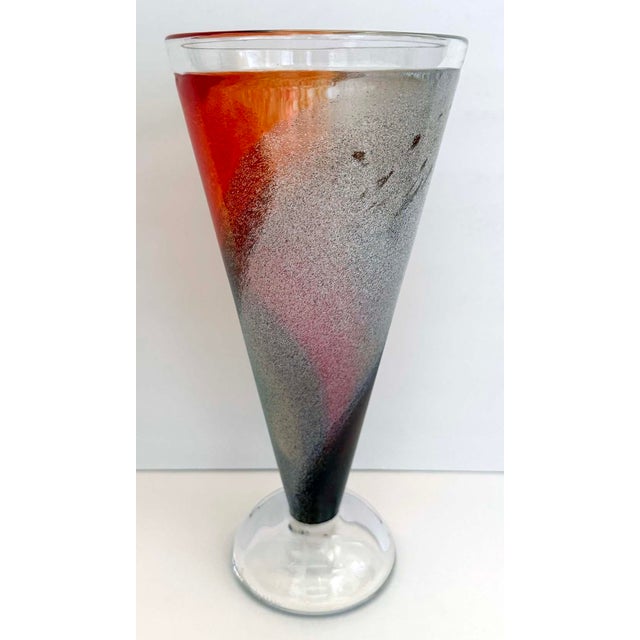 Bright colorful, tall Kosta Boda cone shaped glass vase designed by Kjell Engman. 11 inch tall vase is signed and...
