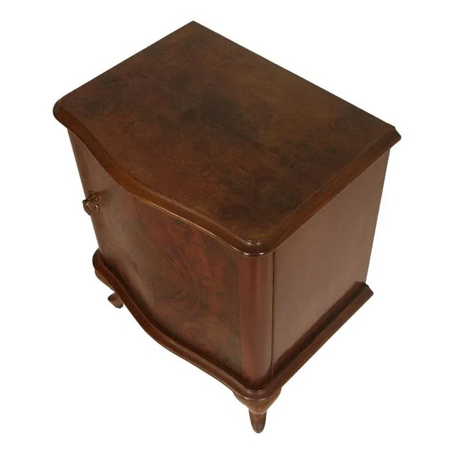 Early 20th century Italian serpentine nightstand in walnut, burl walnut and mahogany veneer interior. One door for a...