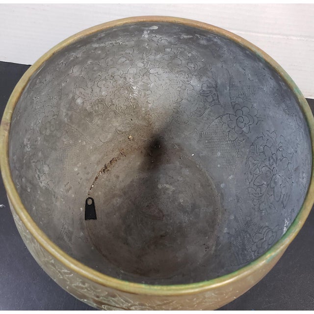 The warmth of brass overtones, this vintage mid-20th-century tripod jardinier planter combines functionality, beauty, and...