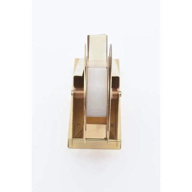 Machine Age meets modern in this vintage sleek and sculptural brass tape dispenser and holder. It is great from all angles...