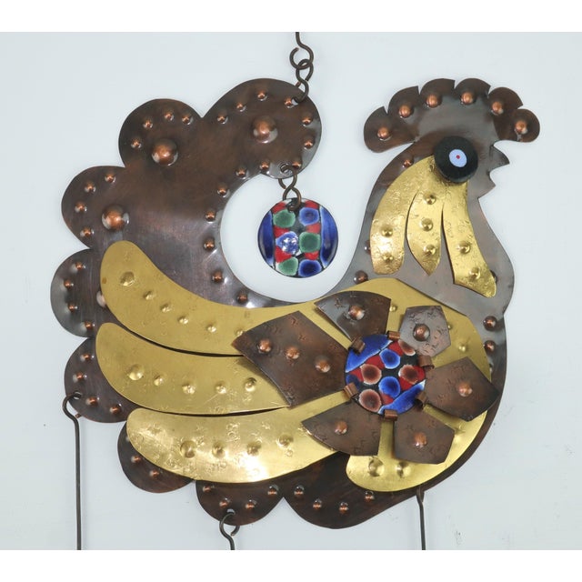 A fun 1970’s sculptural wall hanging with a folk art style mixing layered copper and brass pieces to create a fanciful...
