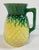 Majolica pineapple pitcher featuring raised relief design with vibrant greens and yellows. Unmarked. Attributed to Arsenal...
