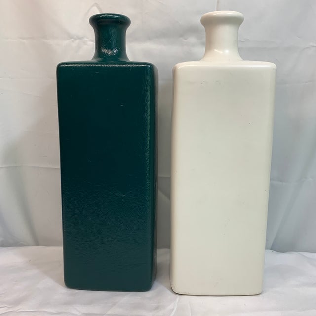 Bring classic mid-century modern geometry to your space with this striking pair of vintage Royal Haeger ceramic bottle...