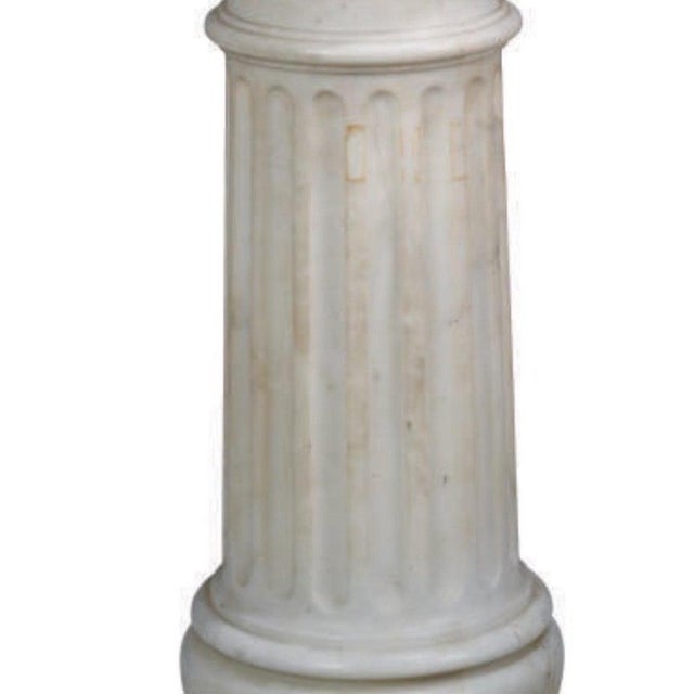 This hand-carved solid marble column features a beautifully detailed acanthus capital atop a classic fluted shaft,...