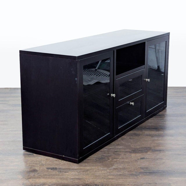 This Jesper Office media console features a sleek dark wood finish with glass doors and drawer fronts. There are a variety...