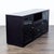 This Jesper Office media console features a sleek dark wood finish with glass doors and drawer fronts. There are a variety...