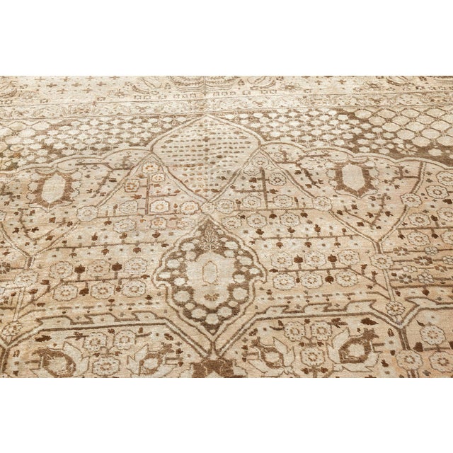 A Northwest Persian late 19th century antique Tabriz carpet, having a dark gray scalloped medallion on a peach field with...