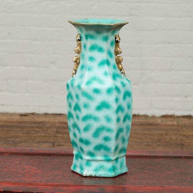 A vintage Chinese turquoise color vase from the mid-20th century, with spotted design and tiny handles. Born in China...