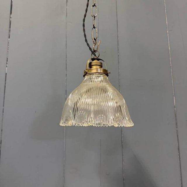 Beautiful small pressed glass holophane pendant lamp from France, 1930s. Fitted with a brass fixture with an E27 socket...