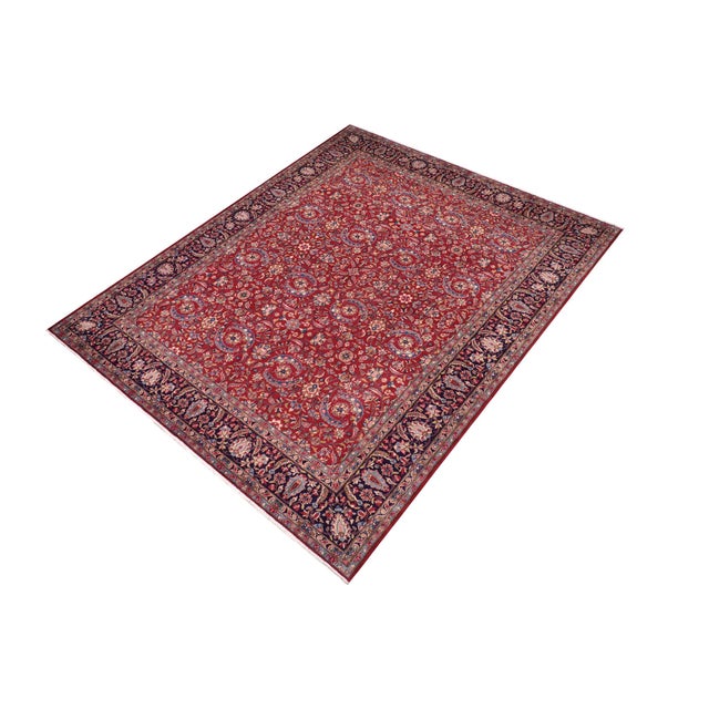 A beautiful hand-knotted wool rug measuring approximately 9'10" x 13'4". This large room-sized carpet features a vibrant...