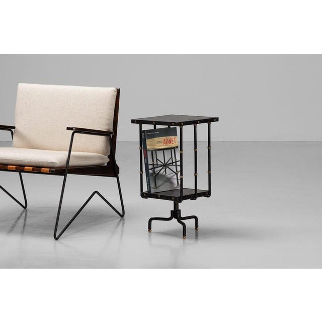 This decorative and uncommon revolving side table, designed by the esteemed Jacques Adnet in the 1950s and manufactured by...