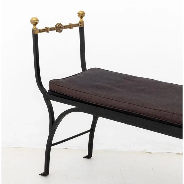 Hollywood Regency Wrought Iron and Brass Bench, with four round finials conjoined by stretches with mask head motif,...