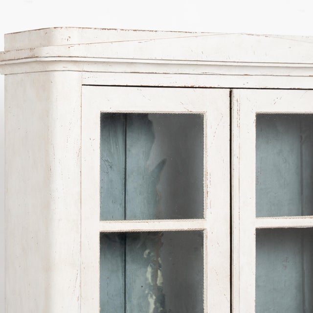 Small Swedish Gustavian pine bookcase featuring a professionally applied layered antique white painted finish with pale...