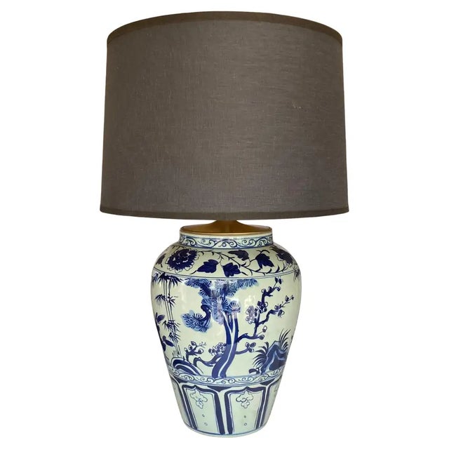 A spectacular early 20th‑century blue and white porcelain ginger jar converted into an elegant table lamp, crafted in the...