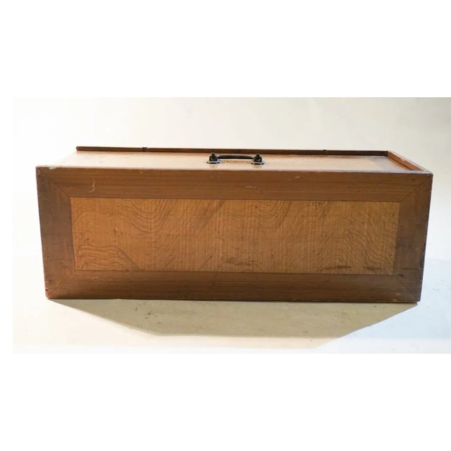 19th century large faux painted maple box, monogrammed with the name M.W. Knox. The sliding lid has an iron handle and...