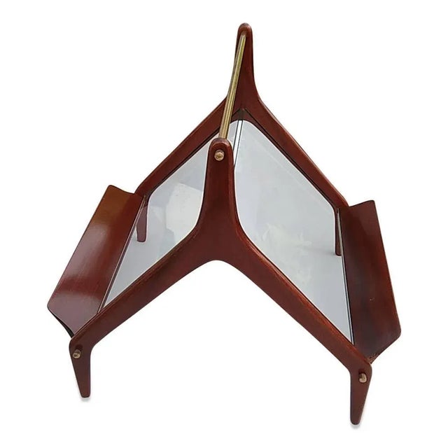 1960s Italian mahogany and glass magazine rack, with brass handle and accents. Recently refinished, this piece...