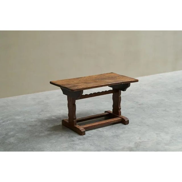 A wonderful antique side table in solid carved oak. Great traditional design with a trestle base with stretchers. Nicely...