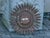 A Spanish gilt metal sunburst light fixture from the Midcentury period, with pierced stars and foliage. This exquisite...