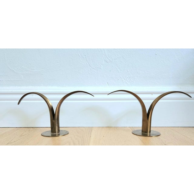 These simple, yet striking, pair of candlesticks made by Yastad Metall with a lily leaf design are the perfect accent on a...