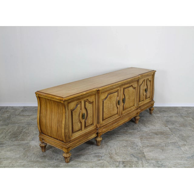 Mid century walnut and bur-wood low console cabinet this cabinet has four door, middle shelving and brass pulls. This...