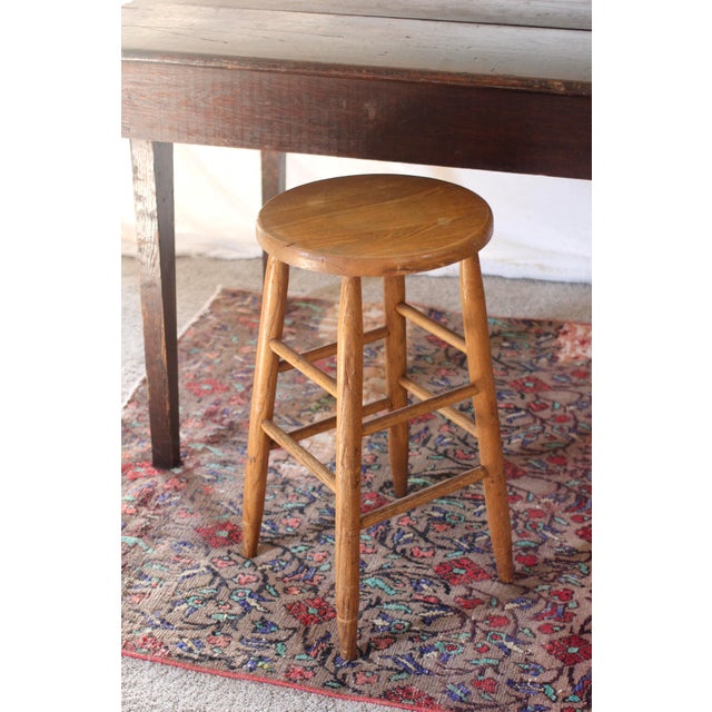 A tall stool with a round seat and turned wood legs handmade. Great farmhouse rustic style. Great patina to the wood and...