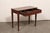 An Italian smaller-sized wooden console table, with satin wood inlay and veneers, from the 19th century. This antique...