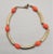 This is part of Chairish’s Costume Jewelry assortment. 1970s goldtone tubular sections with orange glass beads necklace...