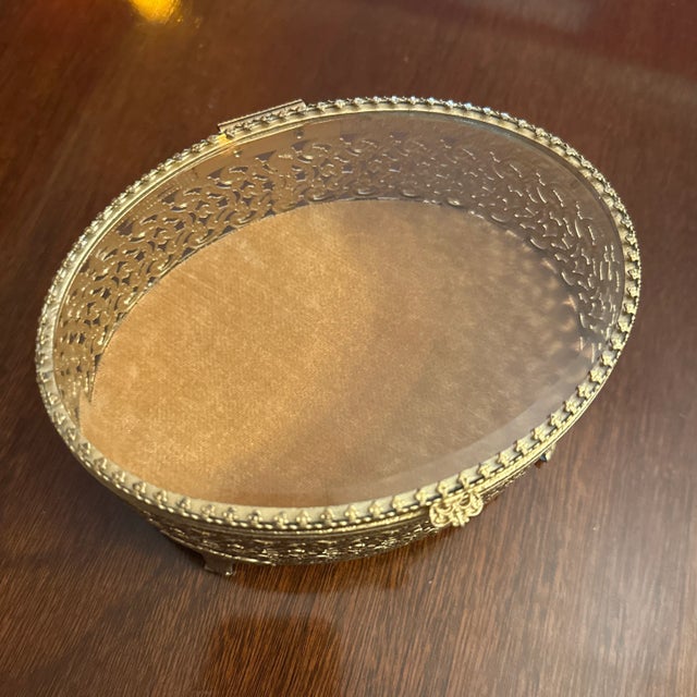 French Louis XV Filigree gold vanity box or jewelry casket of oval form, with ornate rococo designs and scrolled feet with...