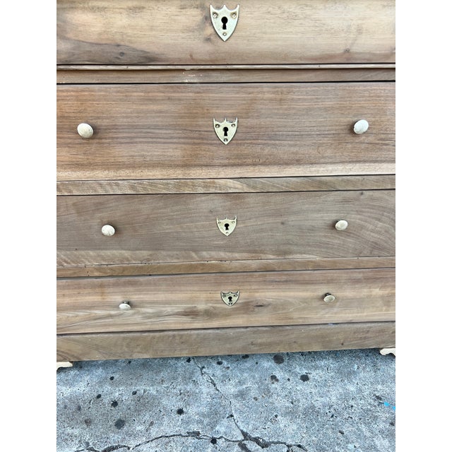 Beautiful French Louis Philippe commode dating to the mid-19th century, featuring a warm bleached walnut finish that...