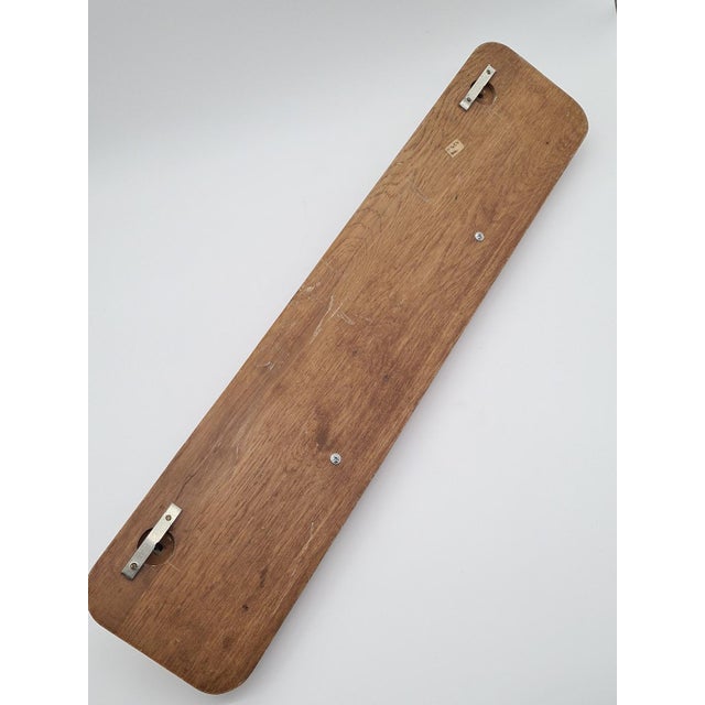 Wooden coat rack with brass hooks, often referred to as a retro, country, or rustic wall rack. It is made of solid wood or...