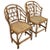 Stylish pair of English Brighton Pavilion style rattan dining armchairs made in the English Brighton Pavilion style. The...