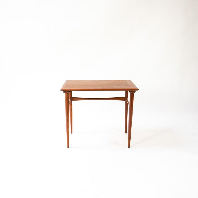This unique piece was originally part of a nesting table set and captivates with its well-proportioned lines and...