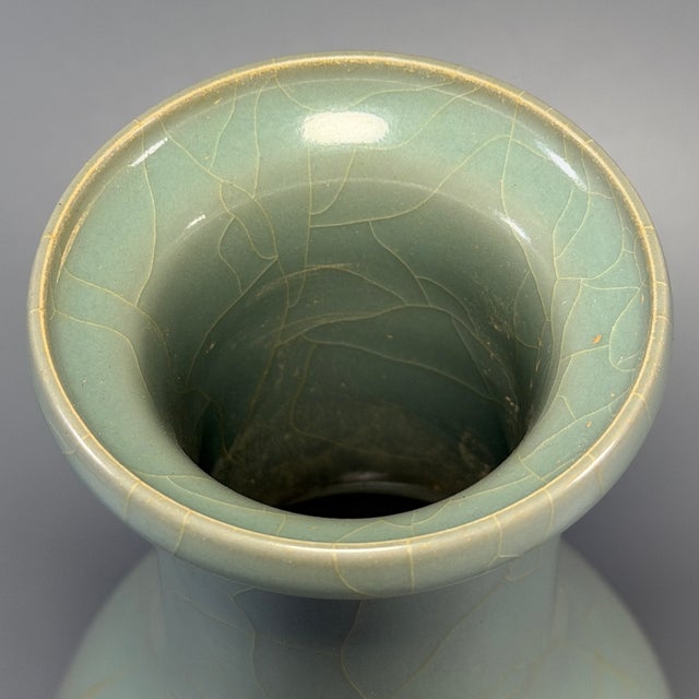Fine antique Chinese celadon pear‑shaped vase. Elegant slender neck rising from rounded pear‑form body, covered in natural...