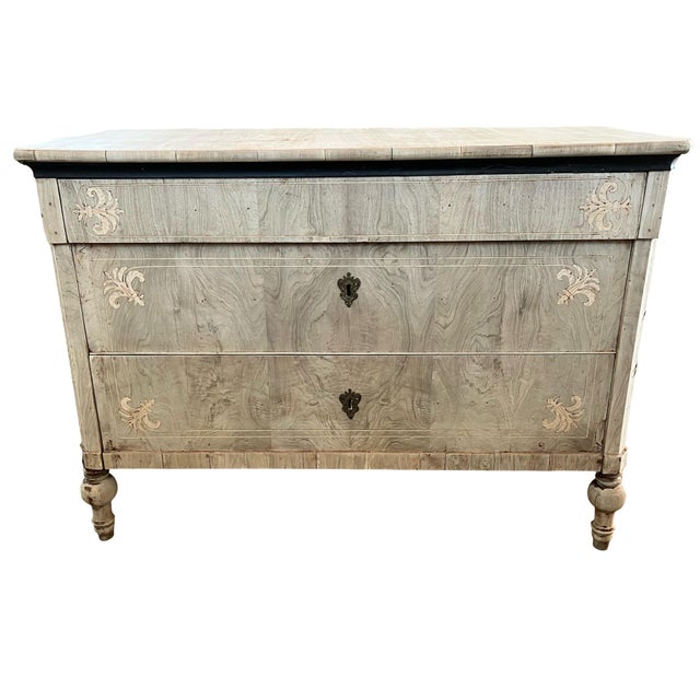 Carlo X commode hand-crafted in Italy in the early 1800s using fruitwood and decorated with walnut book-matched veneer....