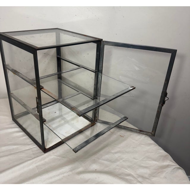 This antique handmade metal mounted glass countertop store showcase is a unique and charming display. Made in the United...