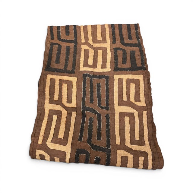 Crafted from authentic Kuba cloth, this long runner showcases the rich texture, intricate geometric patterns, and...