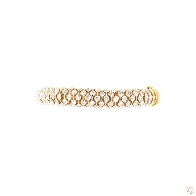 This estate bracelet from our contemporary estate collection centers on an 11.95-carat diamond in a round brilliant cut...