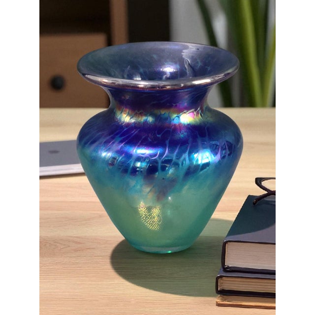 This vintage Art Glass vase is a stunning example of hand-blown iridescent art glass, signed by the artist. The multicolor...
